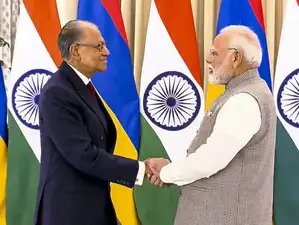 A visual representation of the Indian Rupee and Mauritian Rupee symbols linked by an arrow, depicting the new local currency trade pact.